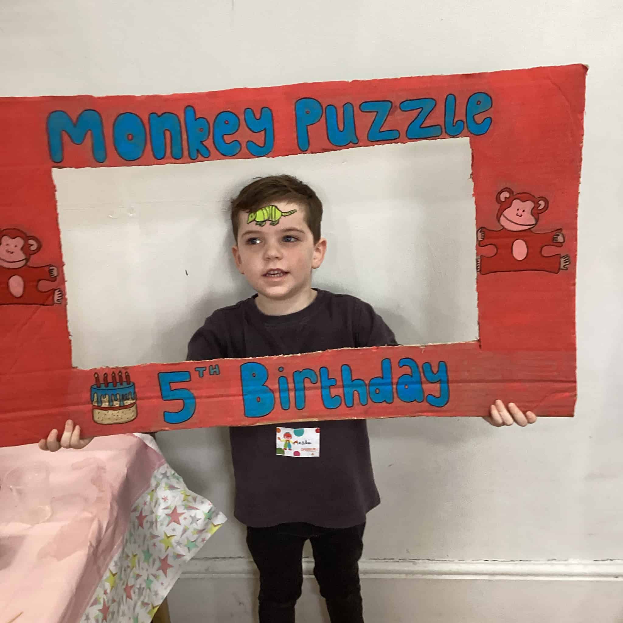Boy holding birthday selfie frame